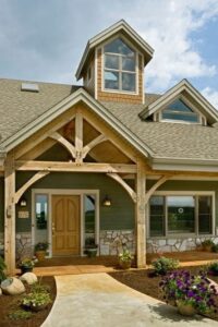 entrance of timber frame home with a large natural timber frame porch