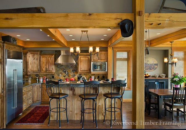 post and beam timber frame layout with stained wood cabinets and kitchen island