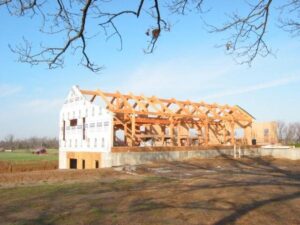 barn style timber frame home with the foundation and timber frame structure completed