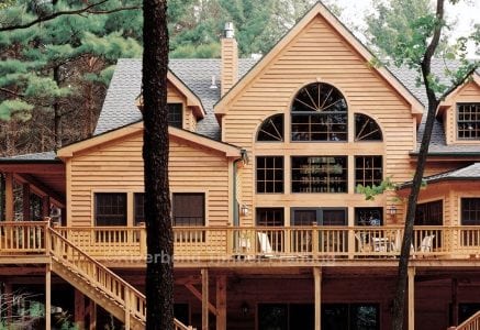 timber frame home with natural wood exterior and wrap around deck with two staircases