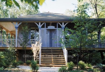 timber frame home with a full wrap around deck and privacy shades