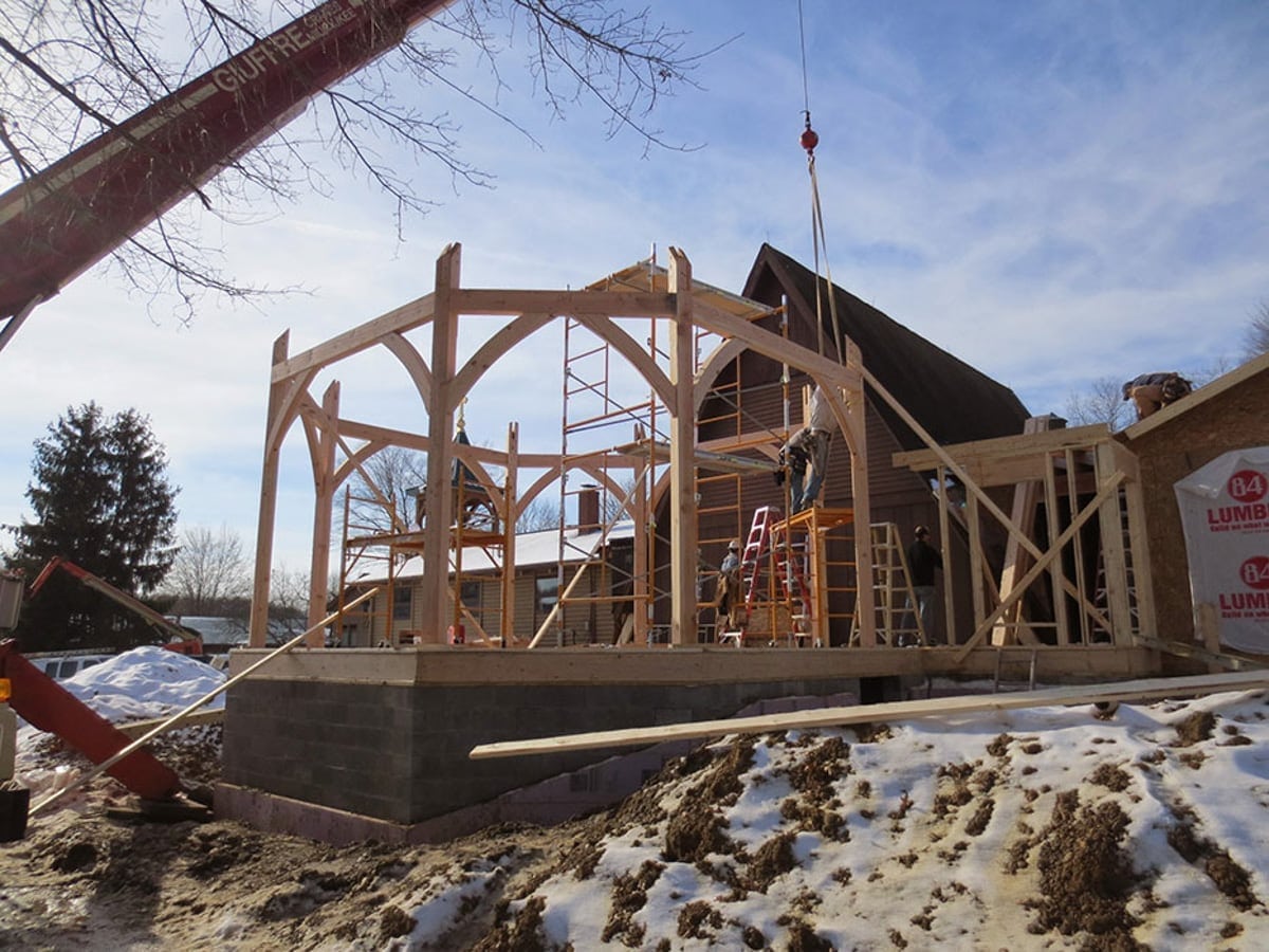 timber frame structure being erected for a monastery chapel