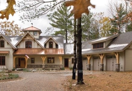 timber frame home with copper roof and three car garage