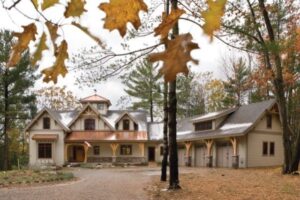 timber frame home with three car garage and copper roofing