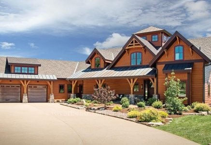 timber frame home with a two car garage and long driveway