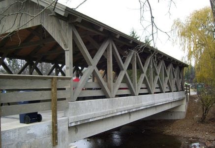sleepy-hollow-bridge-side.jpg - timber frame bridge with grey exterior timber frame and concrete foundation